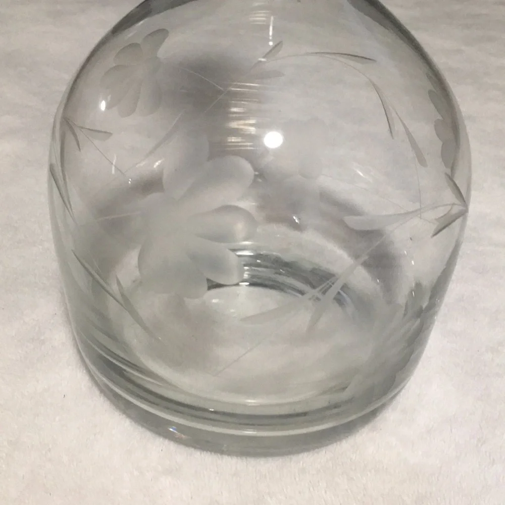 Floral etched glass decanter with stopper.